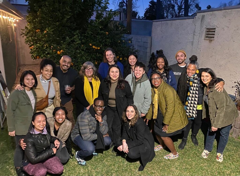 Photo of NFG staff and board in a backyard at dusk.