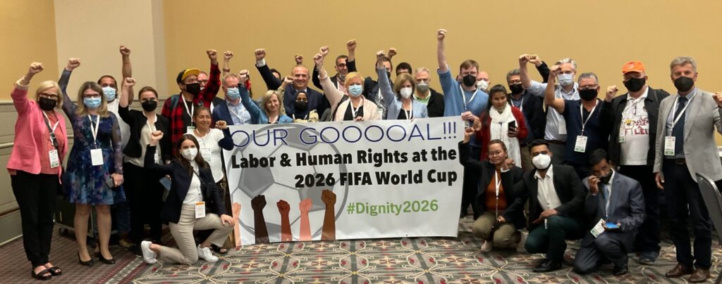 Photo of organizers holding a banner that reads: Our Goaaaaal! Labor and Human Rights at the FIFA World Cup.