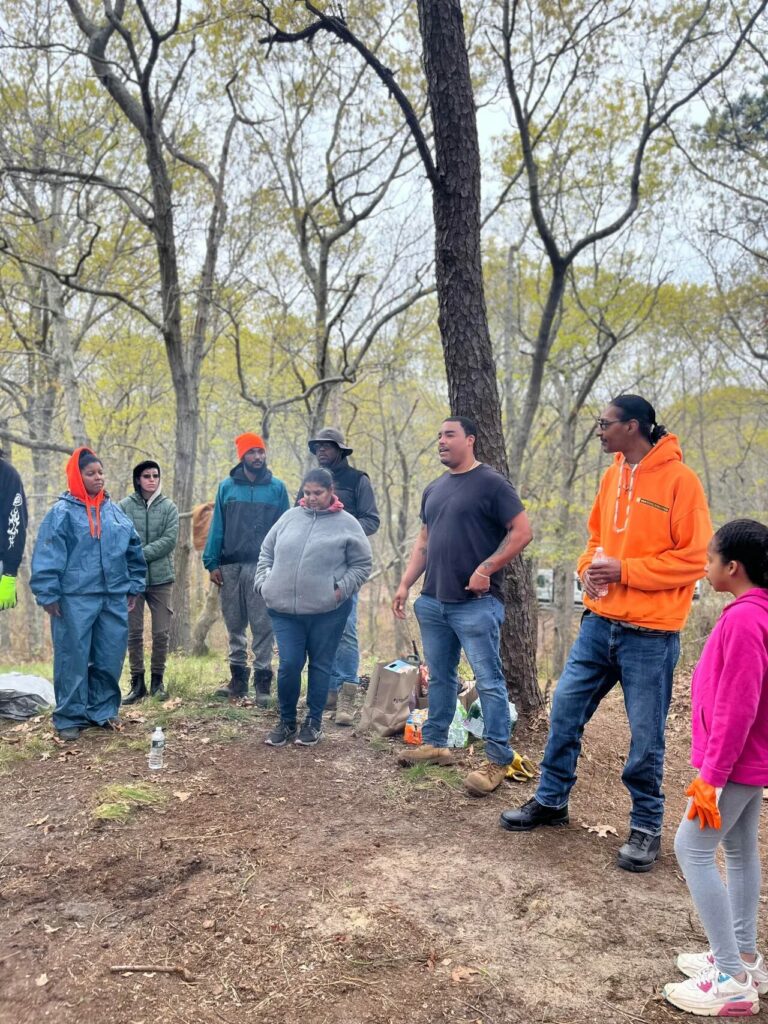 Shane Weeks with Boys and Girls Club of the Shinnecock Nation, cleaning ceremonial grounds on Shinnecock territory. 