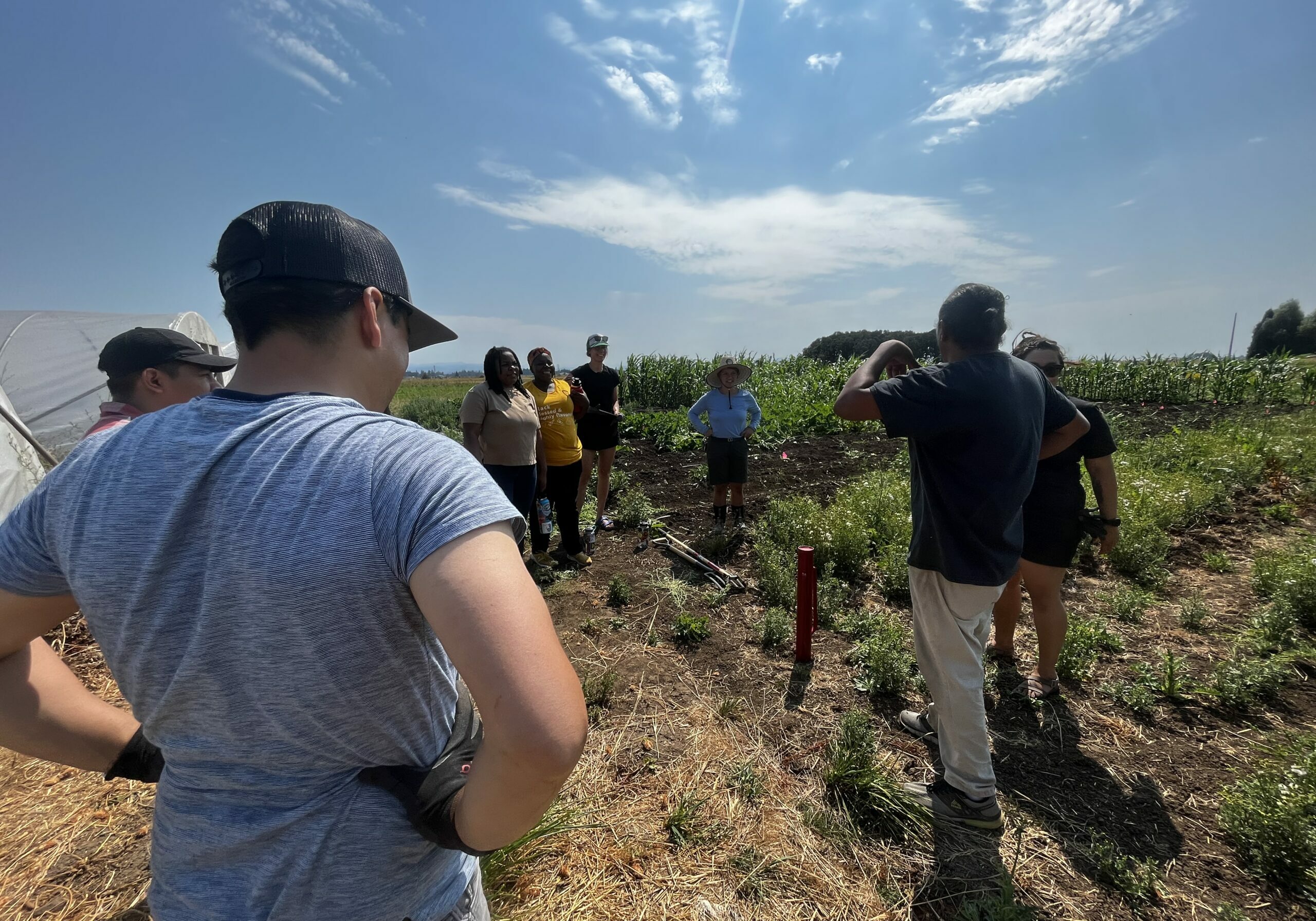 People gathered round in a circle at the Anahuac Farm